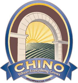 An arched window frames sunlit farmland with "CHINO Where Everything Grows" on a blue banner below.